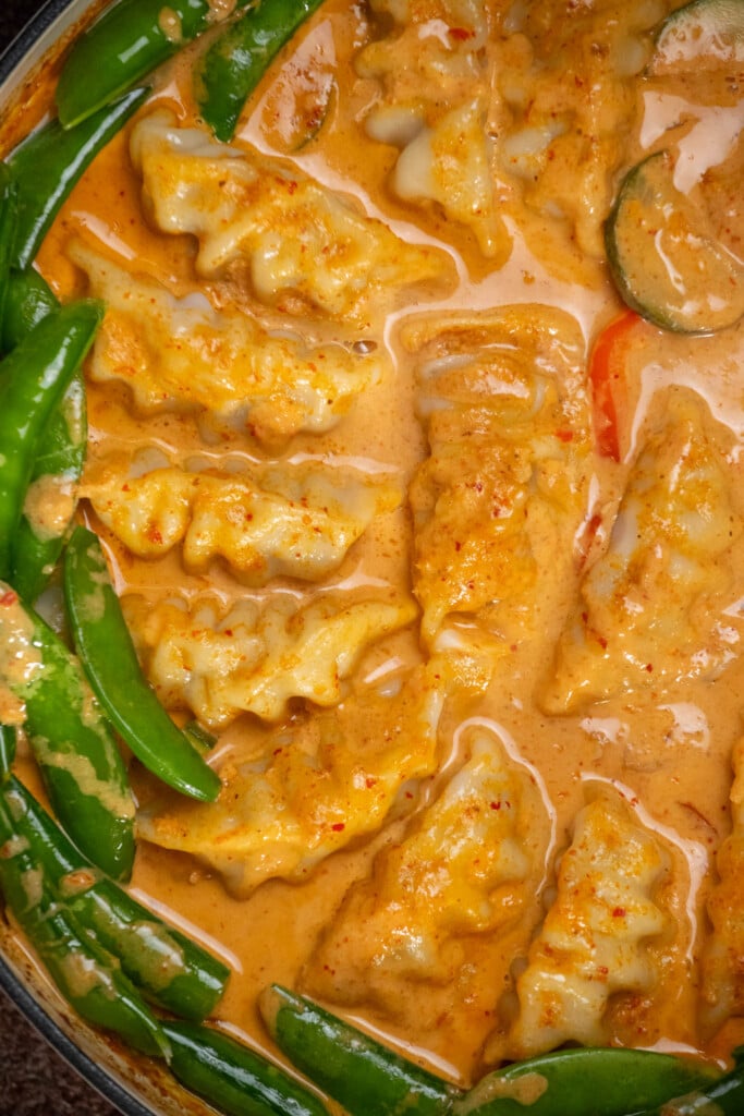 after 30 minutes, remove dish and uncover. Arrange snap peas around the outer edge of the pan. 