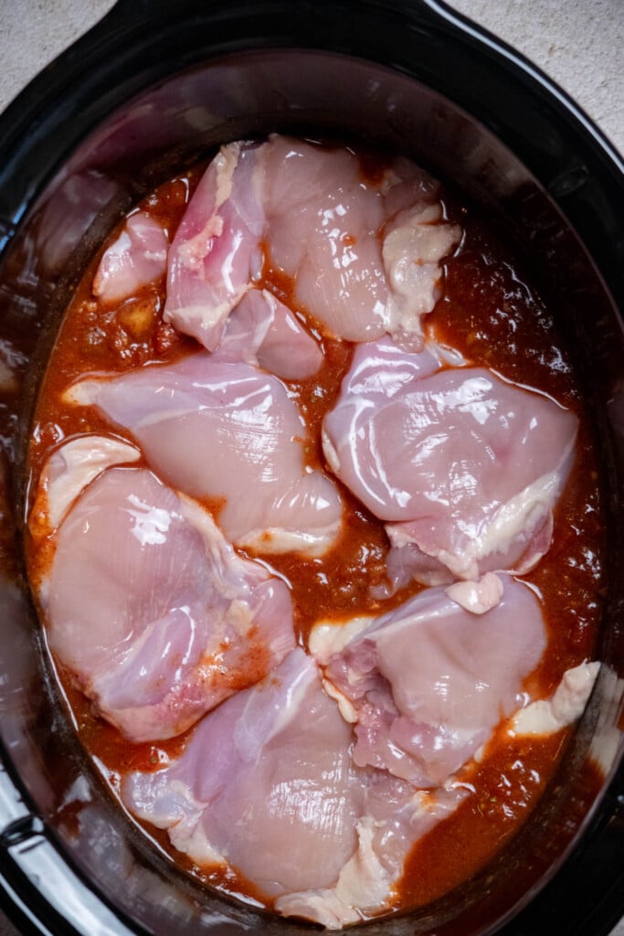 add chicken thighs to the crockpot 