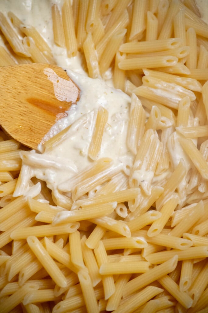 drain the pasta and add to the pot with the sauce, reserving a bit of pasta water to add to the pot to thin  the sauce, if needed. 