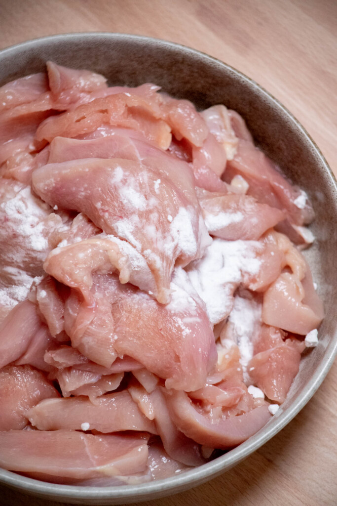slice your chicken into thin, &frac14;" strips, and add to a bowl with the baking soda 