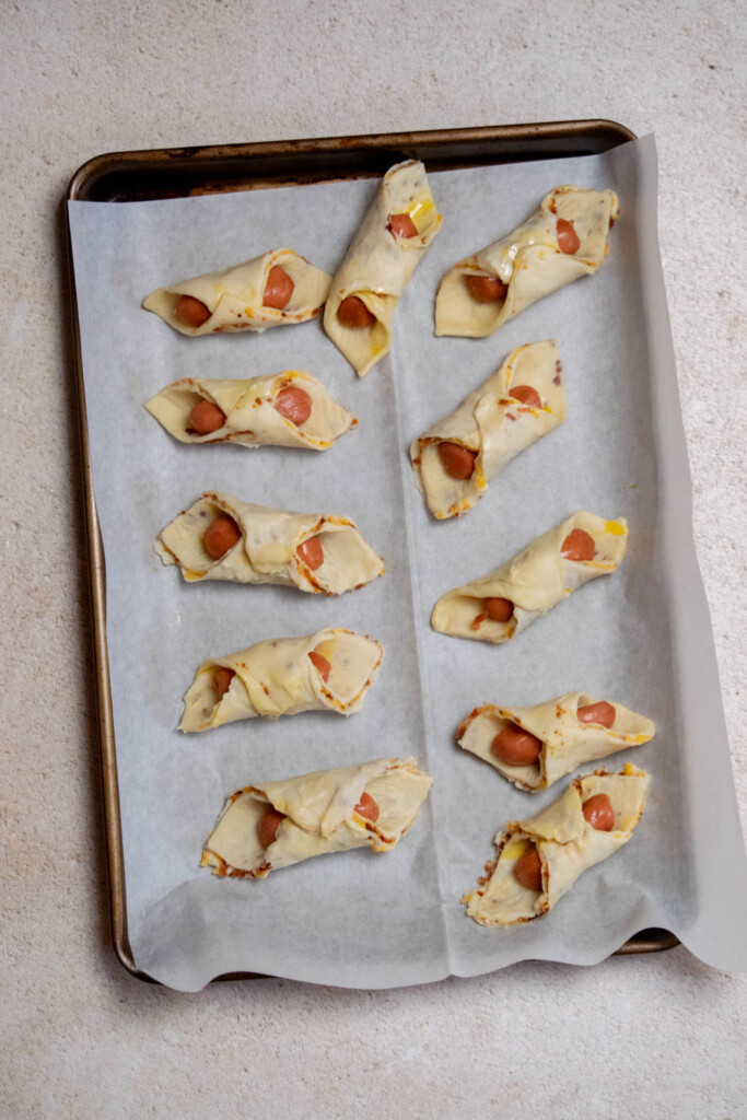 seal each pig in a blanket in the center, and transfer to a parchment paper lined cookie or baking sheet. 