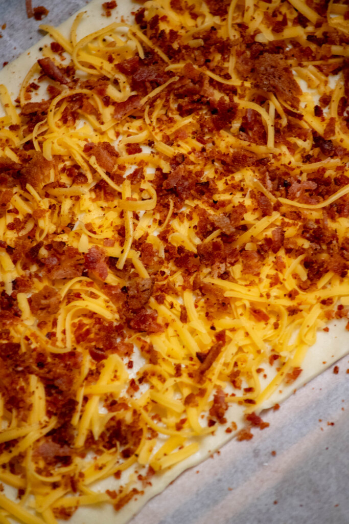 sprinkle over half the cooked and chopped bacon