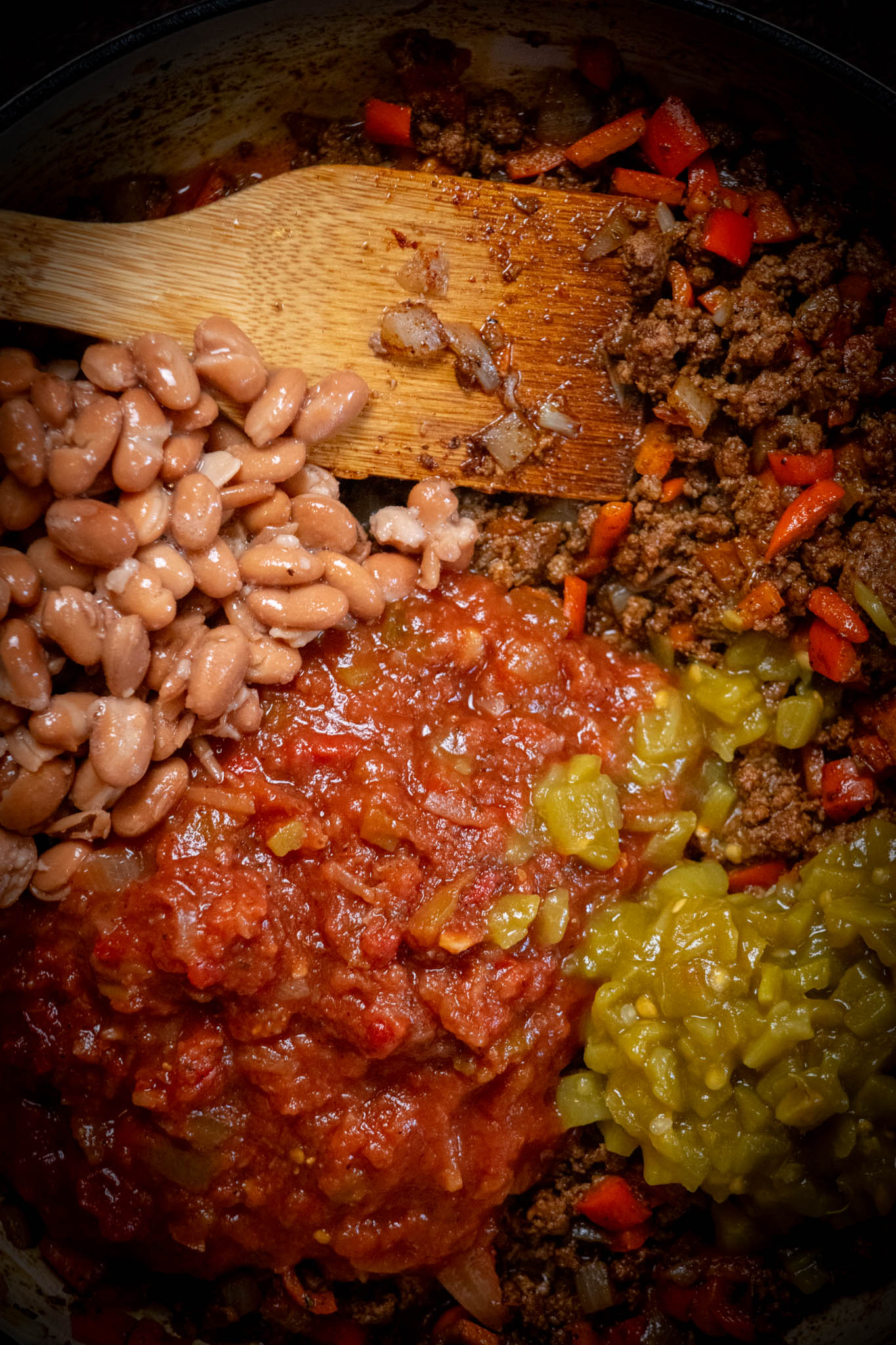 Add salsa, diced chilis and pinto beans, stir to combine, and simmer until warmed through, about 7 minutes.