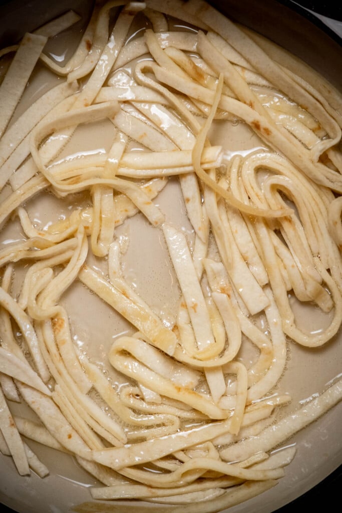 heat avocado oil in a large skillet until shimmering and just starting to smoke, then add your tortillas to fry