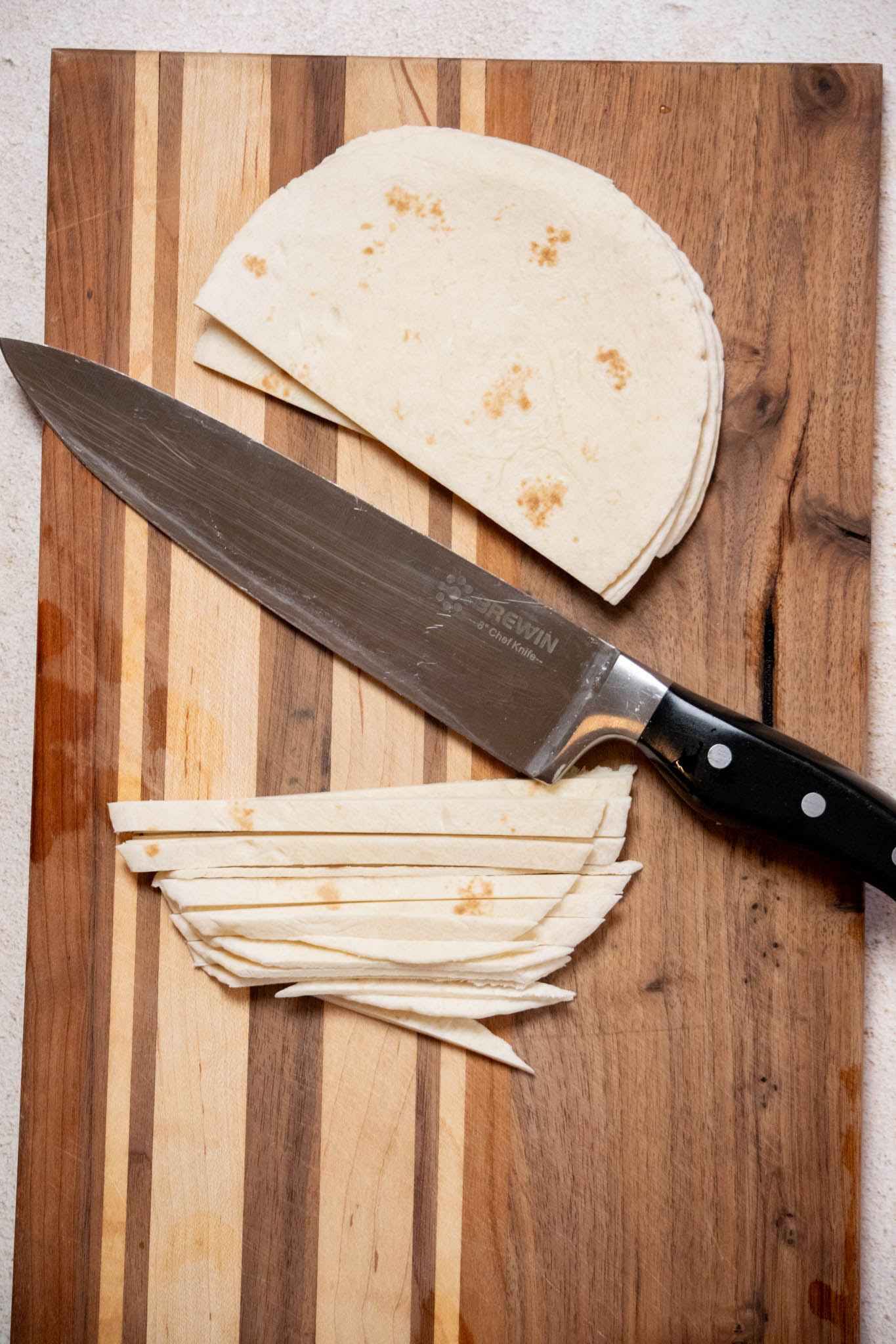 Preheat your oven to 450 degrees f. slice your tortillas into thin strips (about ¼" thick). 