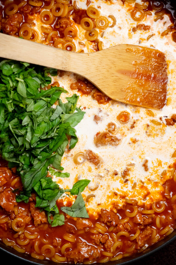 Once liquid is mostly reduced, stir in heavy cream and basil and bring heat to medium. Cook 10-12 minutes more covered . Until pasta is cooked through and sauce is thick and creamy.