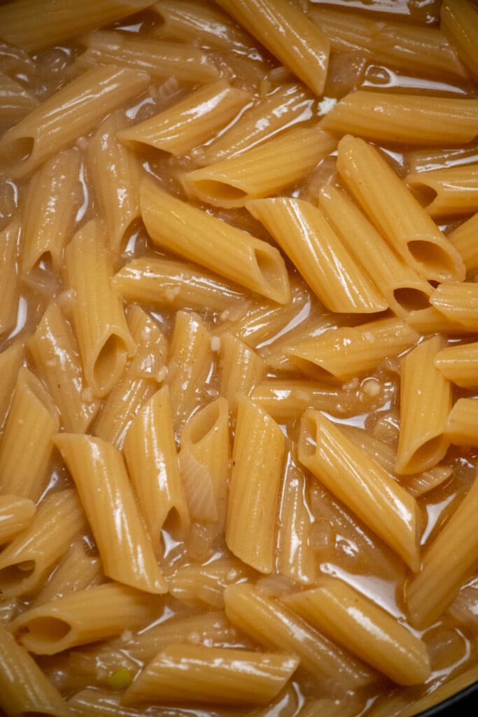 Once boiling, reduce heat to low, and cook, stirring occasionally, for 12 minutes, until liquid is mostly reduced, and pasta is nearly finished. 
