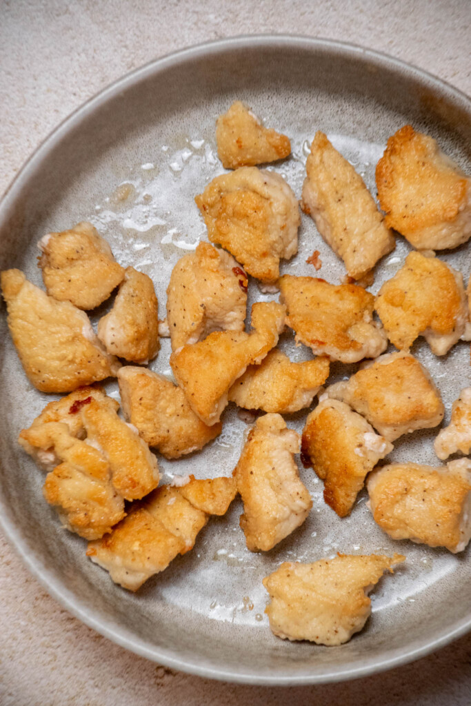 Flip and cook 2 minutes more on the second side, then transfer to a bowl, and repeat with the second batch of chicken