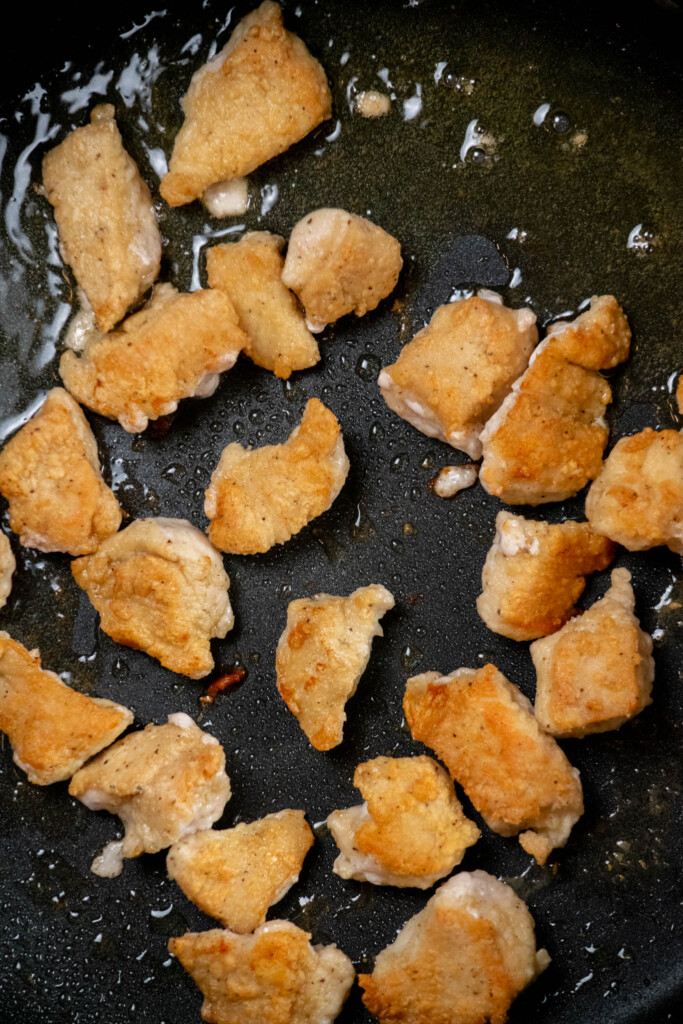 Heat olive oil until shimmering over medium heat, and (working in batches) cook chicken undisturbed for 3-4 minutes on the first side, until golden brown