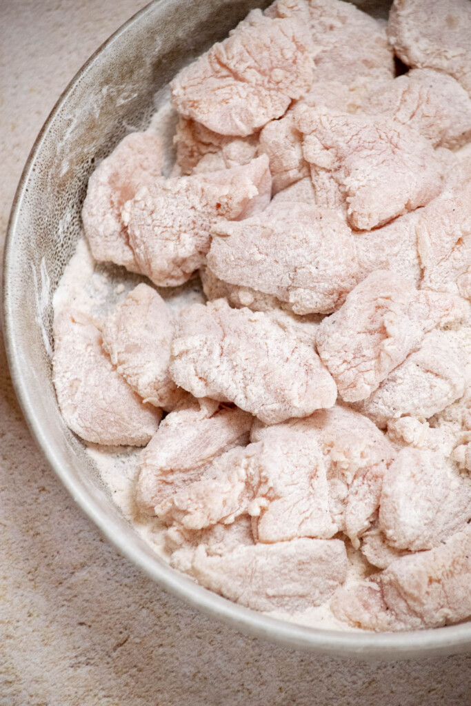 Toss chicken pieces wit flour to give them a light coating, and shake off any excess flour