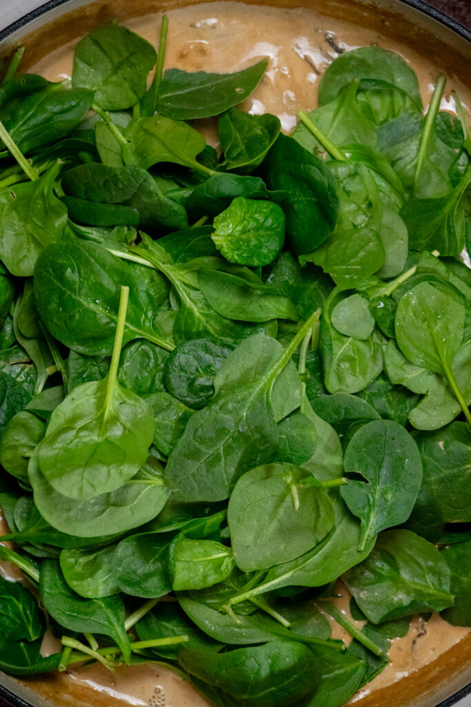 Once the sauce is thickened, add in the fresh baby spinach 