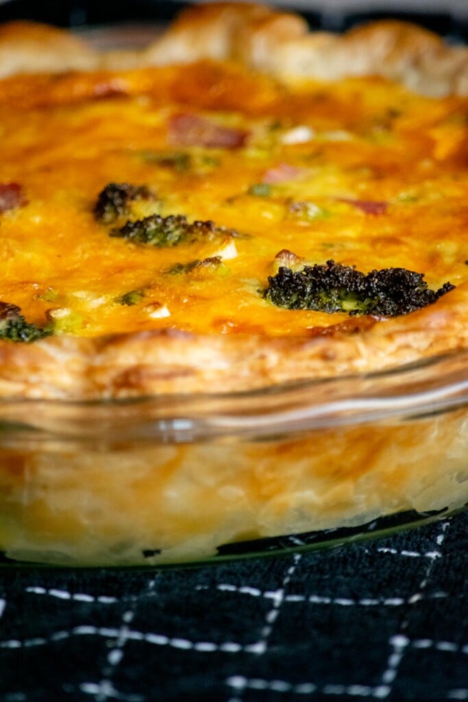 Bake the quiche in a preheated oven for 60-75 minutes, until crust is golden, eggs are set, and the top is golden brown. 
