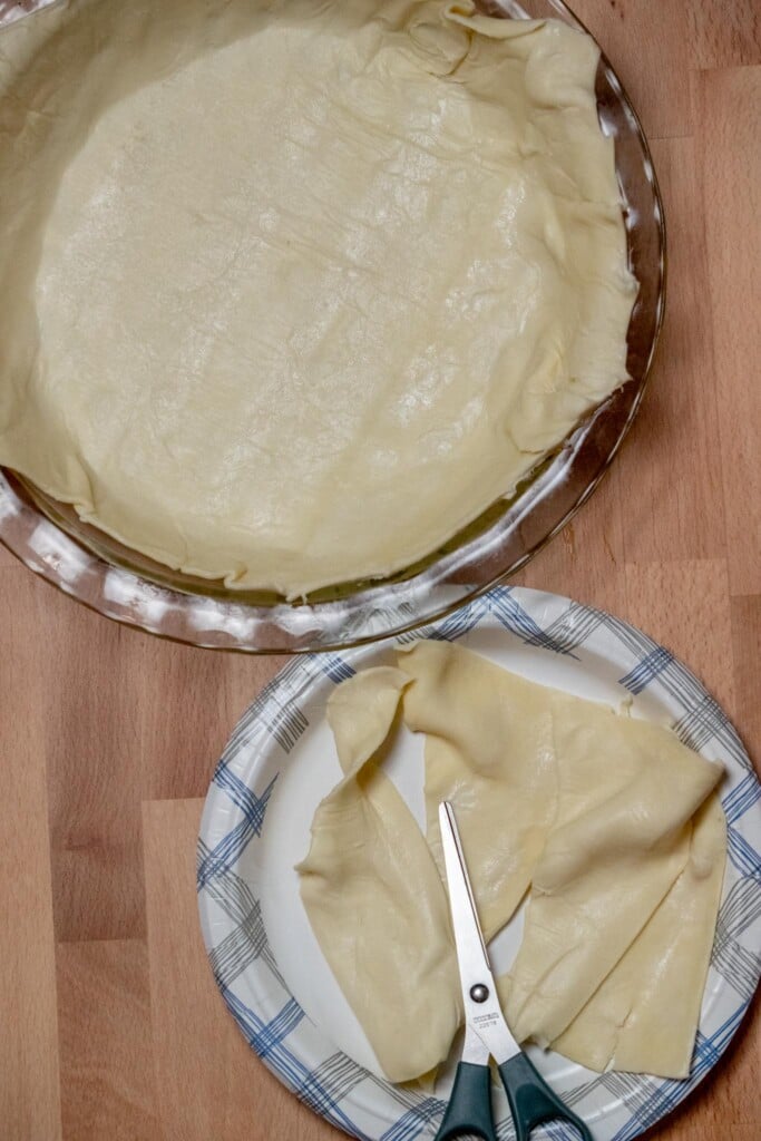 using sharp kitchen scissors, cut away and overlapping excess pieces of dough. 