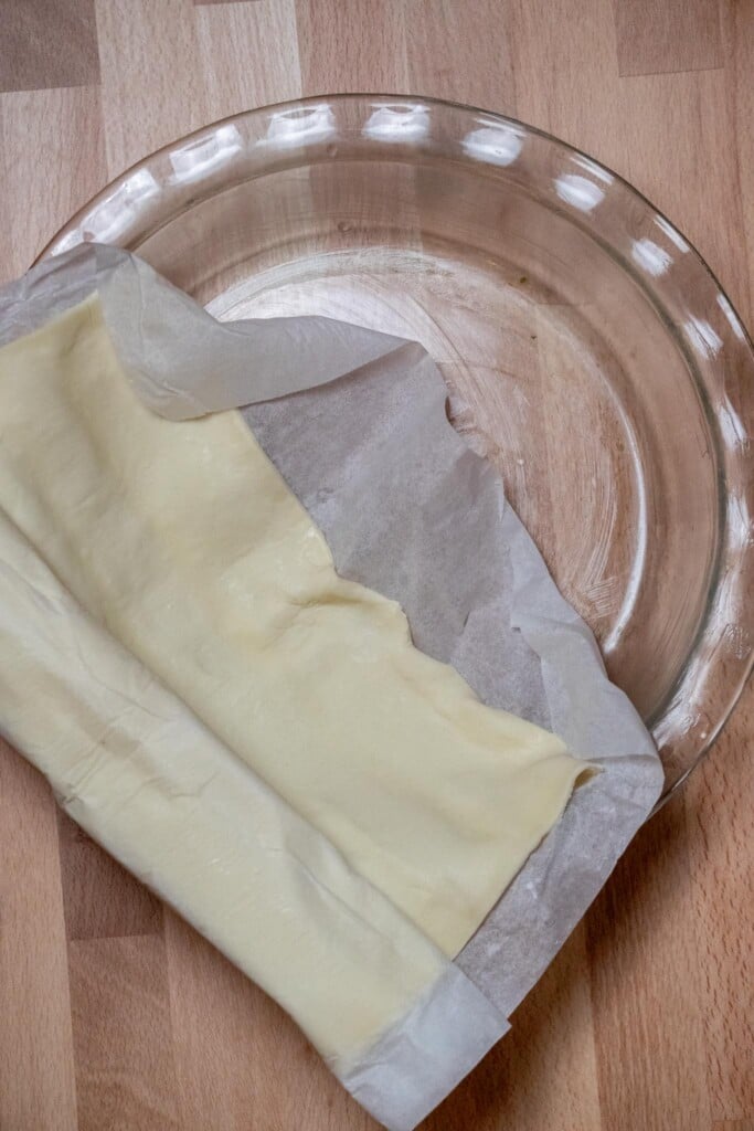 Reduce oven temperature to 375, and grease your deep dish pie plate. Gently unroll the puff pastry.