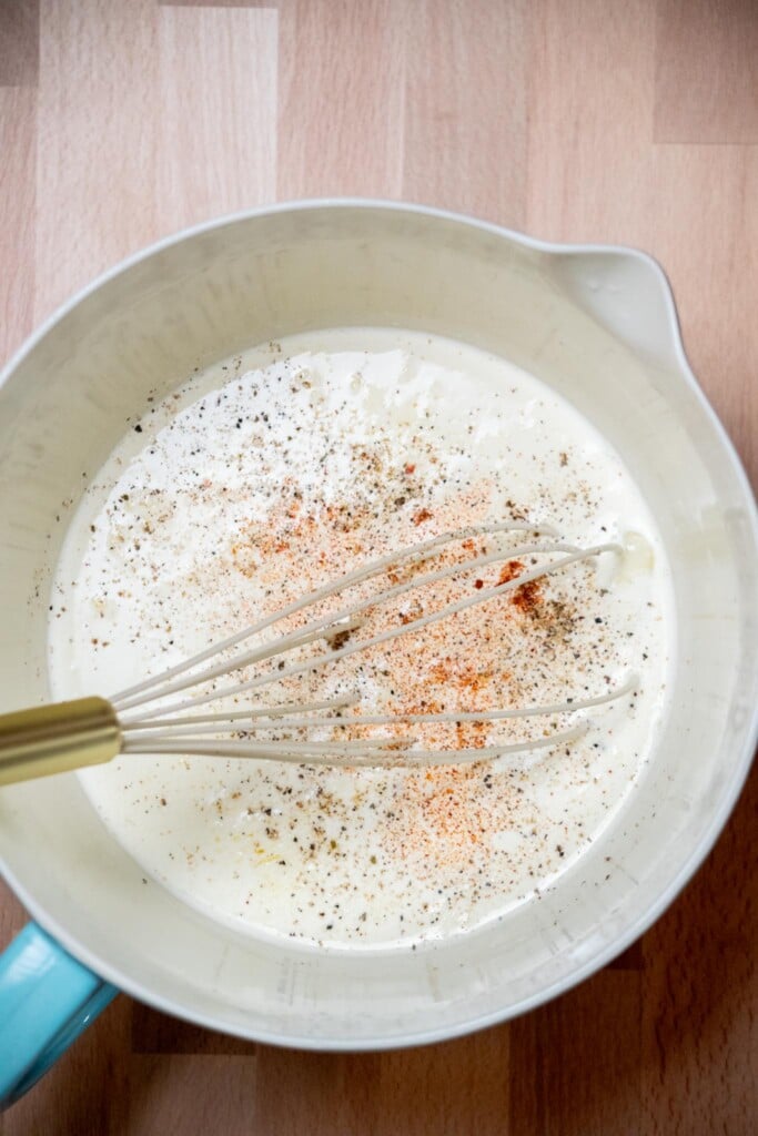 Whisk together the eggs, cream, salt, pepper, and cayenne until well incorporated. 