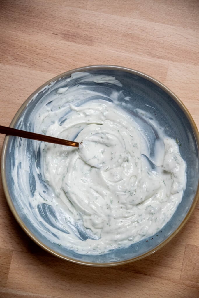 Mix room temperature Greek yogurt, dill, garlic, lemon juice, salt, and pepper to make the tangy yogurt for the base, and set aside. 