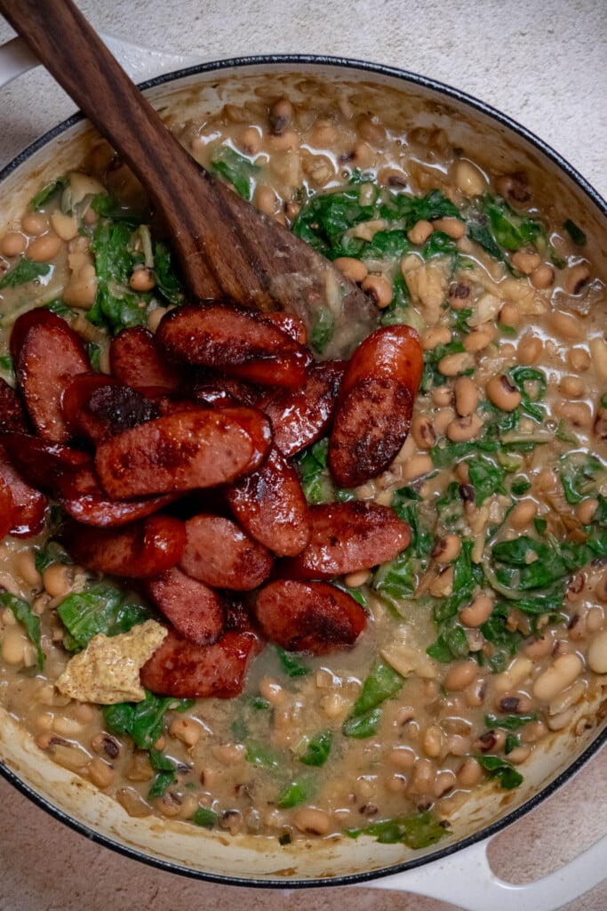 Add back the reserved browned sausage and any accumulated juices, along with the dijon and lemon juice 