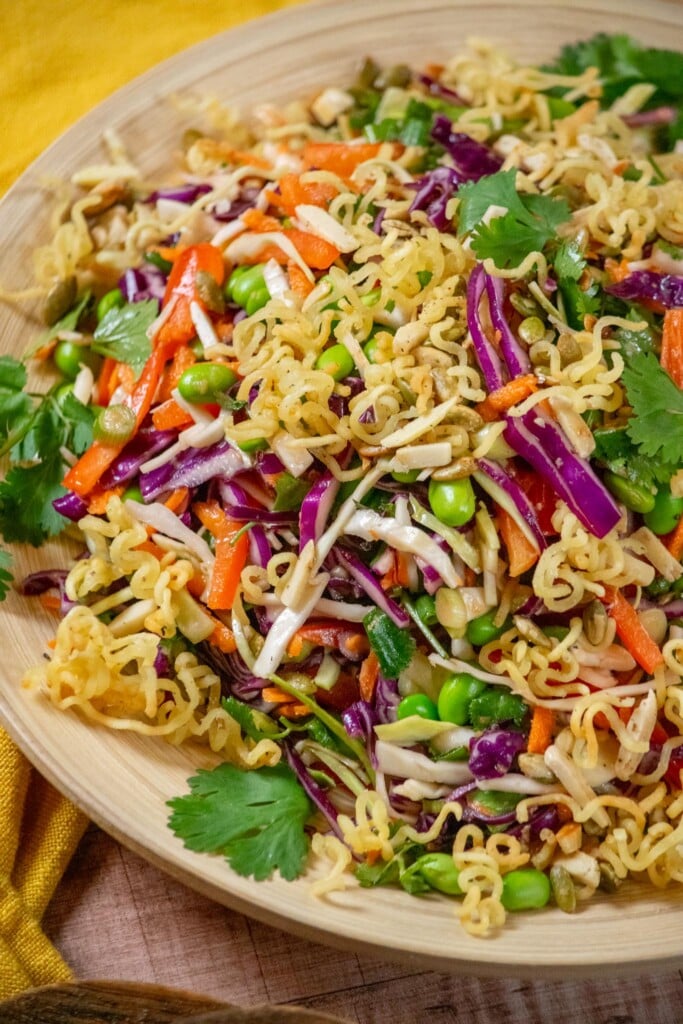 Give the salad a quick toss, then arrange on a platter, and top with cooled crunchy ramen topping. 