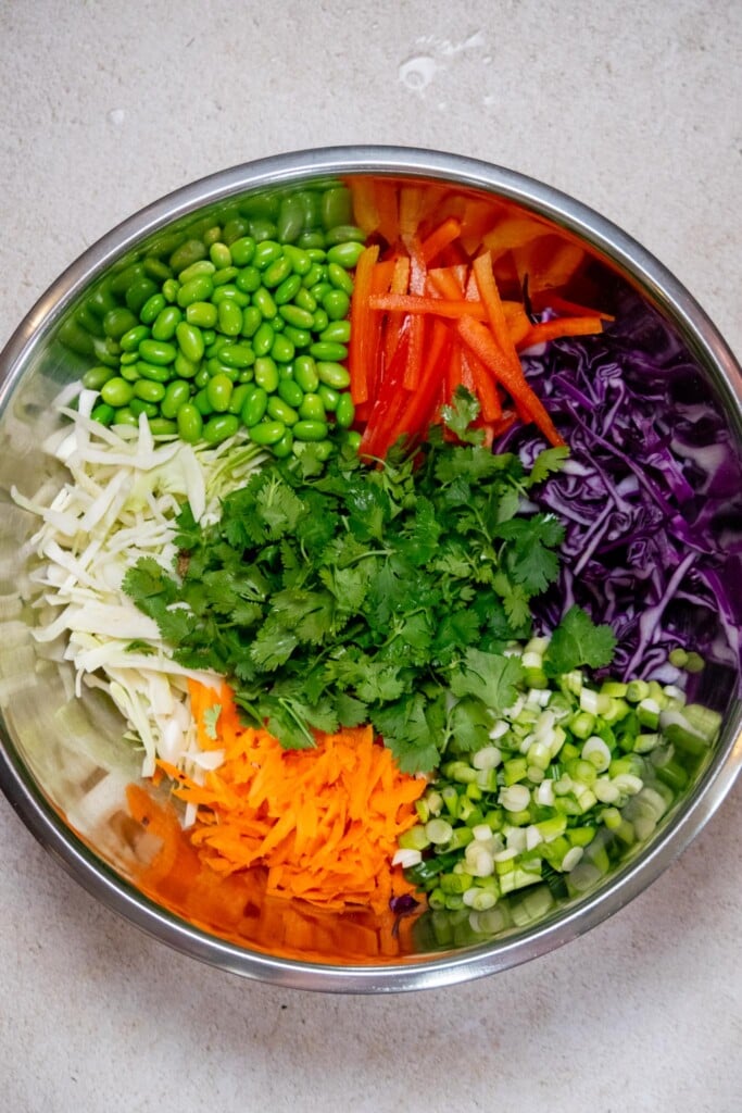 Add the prepped veggies, cilantro, and edamame to a large bowl. 