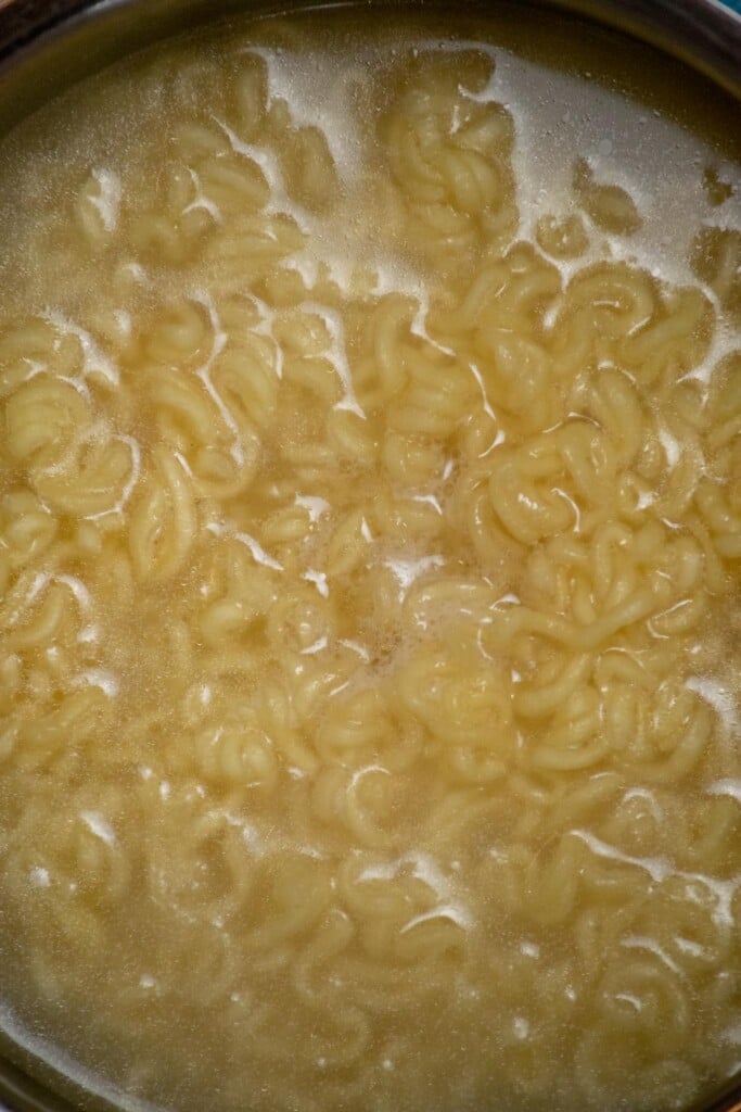 Break the dry ramen noodles up into small chunks with your hands, and boil for 2-3 minutes, until just below al dente. 
