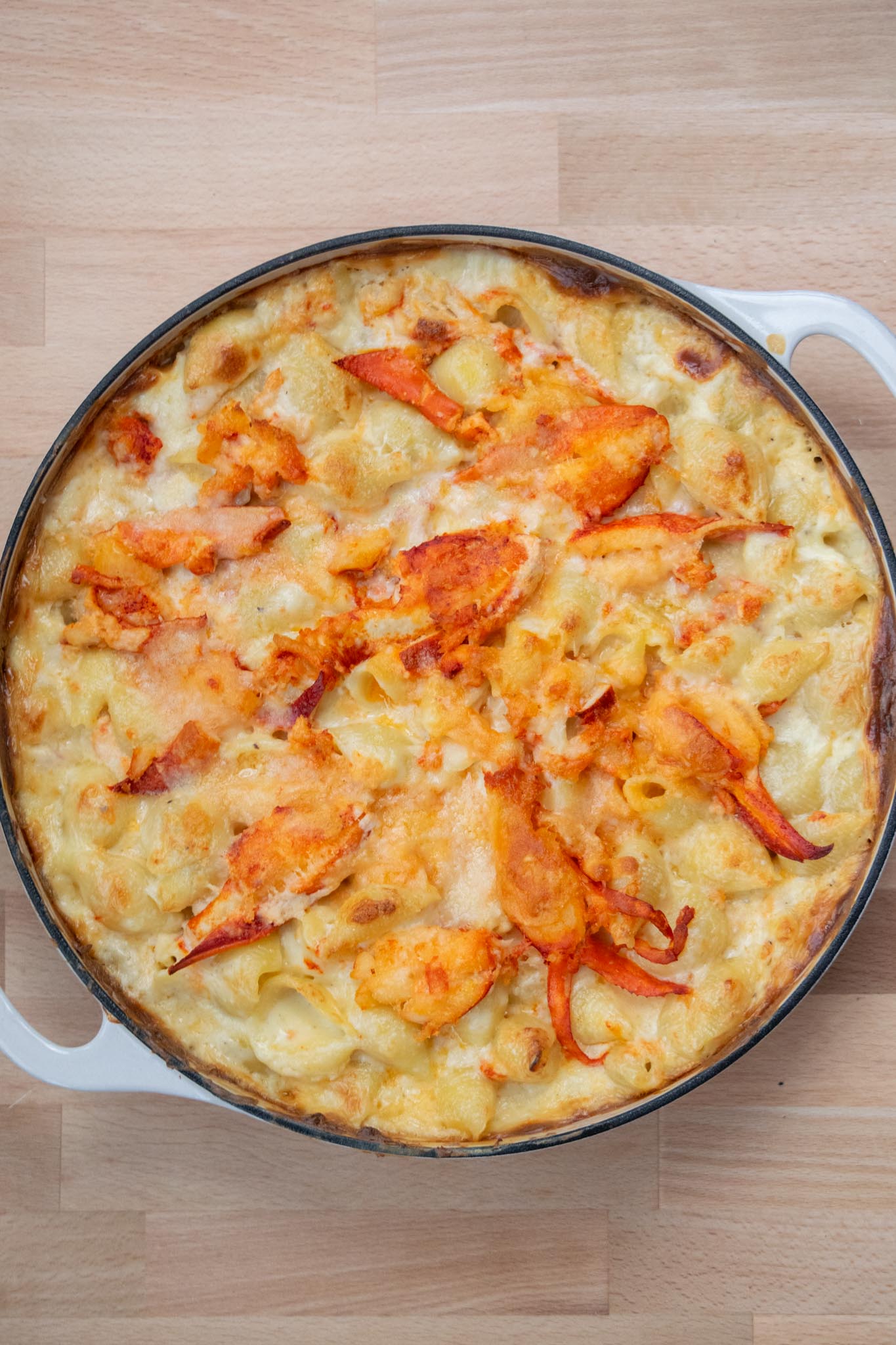 Baked lobster mac and cheese out of the oven with a lightly browned top.