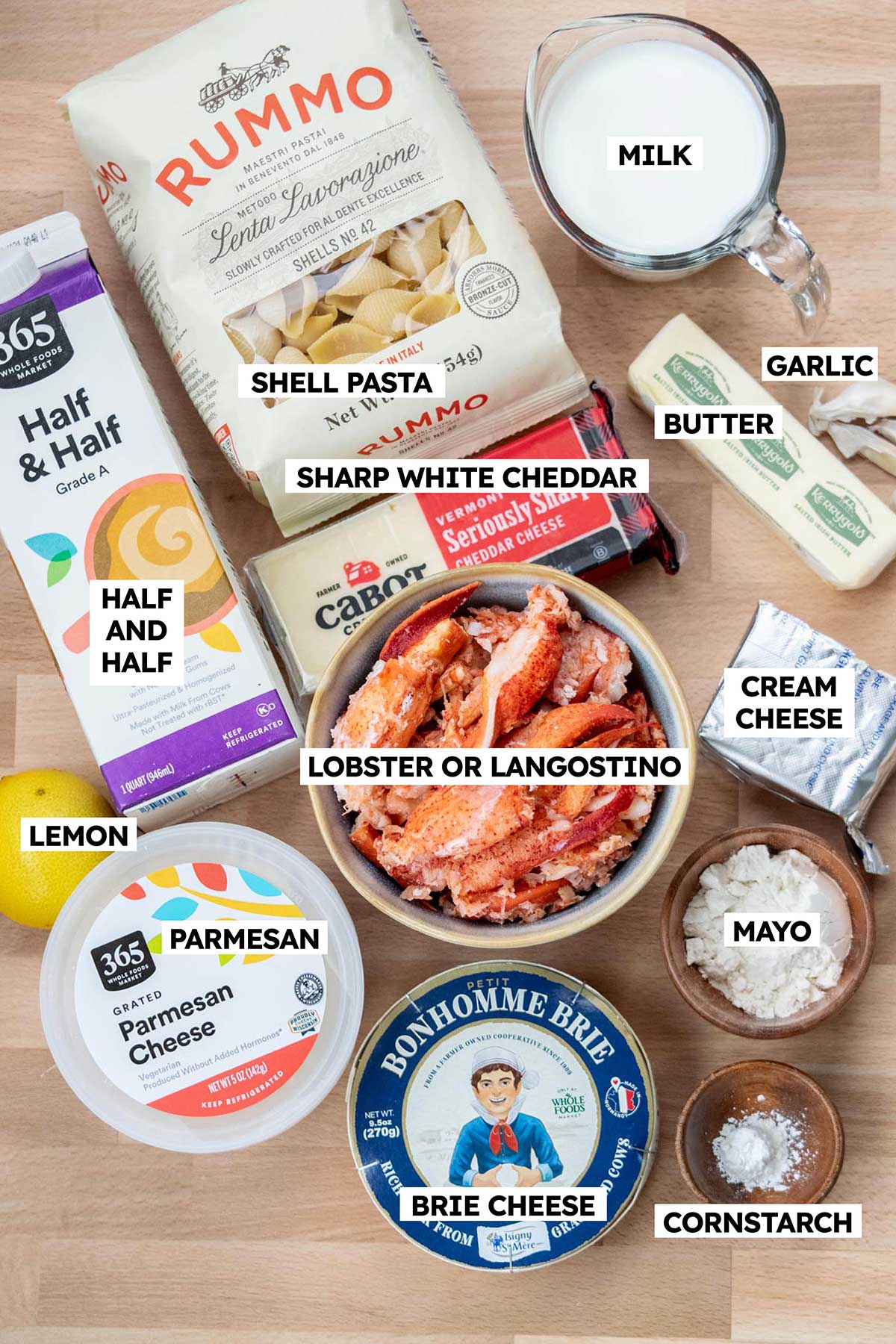 Ingredients to make creamy lobster mac and cheese on a table.